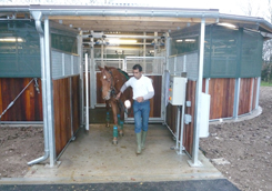 Horse leaving via covered entrance